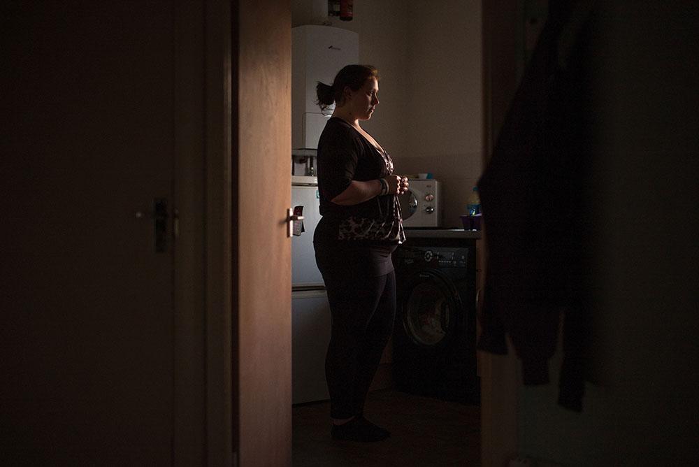 Woman stood alone in her kitchen