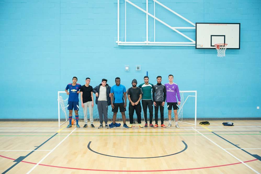 A group of footballers from Chesham standing in a Gym
