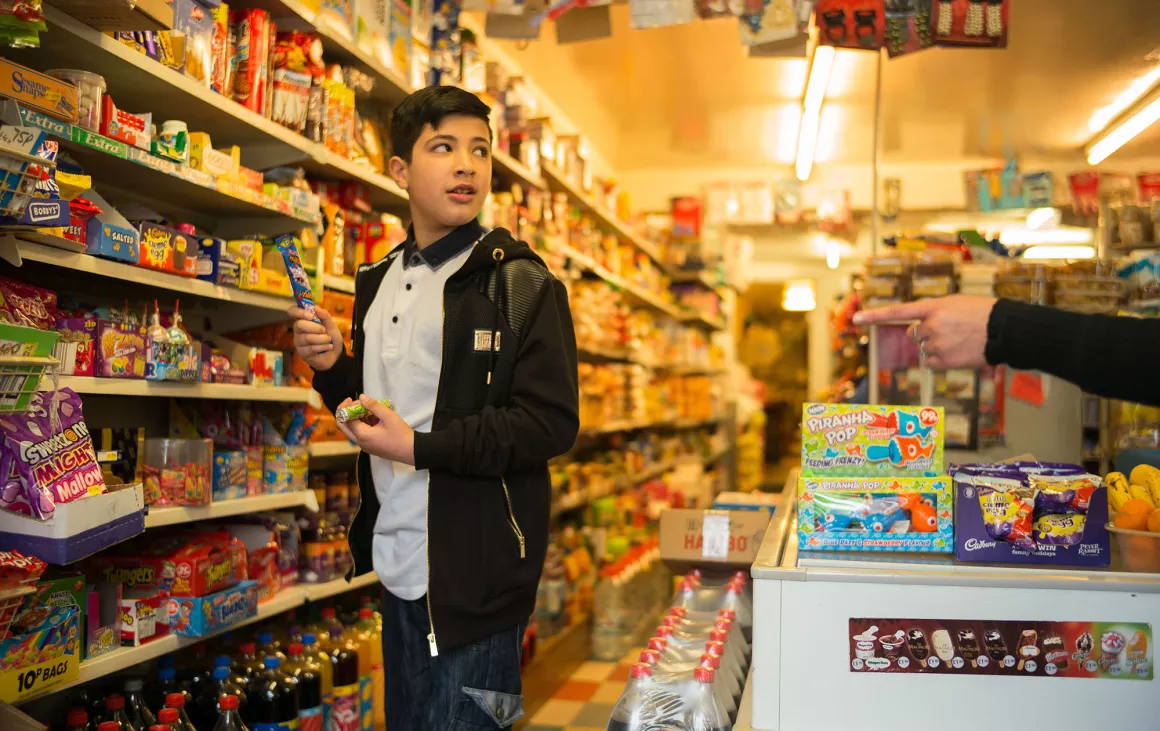 Boy in sweet shop selecting sweets