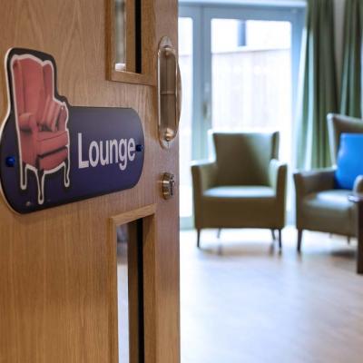 Sign for the lounge at a residential home providing social care
