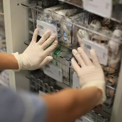 NHS worker pushing drawer of bandages
