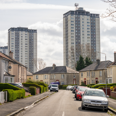 Photo of a street with houses and cars