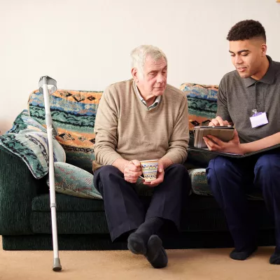 Senior man with care worker