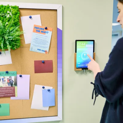 A woman reaches out to answer a call on an iPad