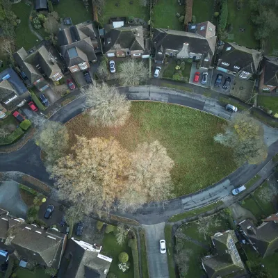 Aerial view of large houses with gardens and trees