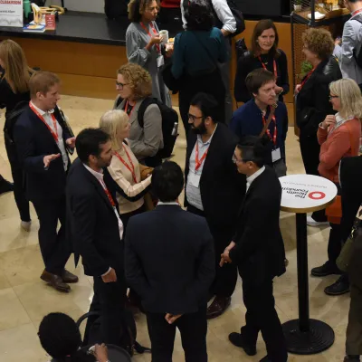 A group of people talking in a Health Foundation conference hall