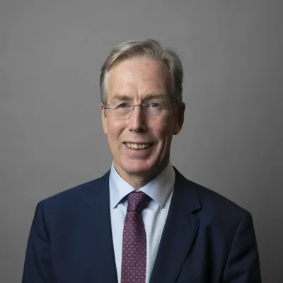 Headshot of Sir David Behan